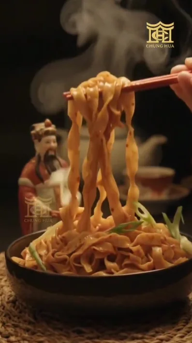 Steaming noodles lifted with chopsticks, from a restaurant food film
